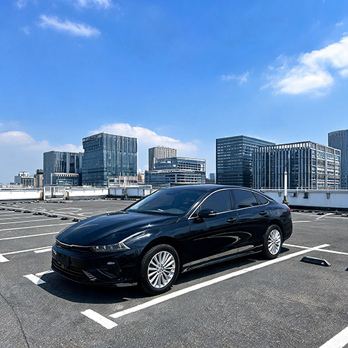 Black family sedan parked in a city parking lot